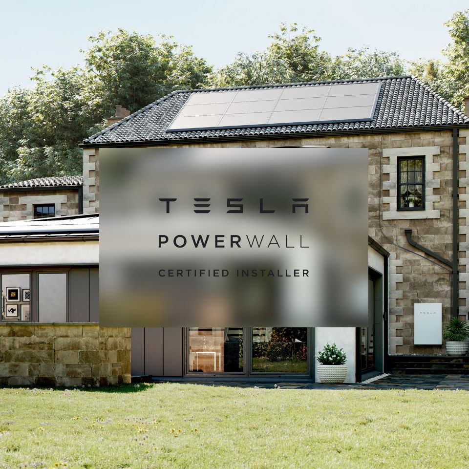 Tesla Powerwall battery installed on the side of a stone house